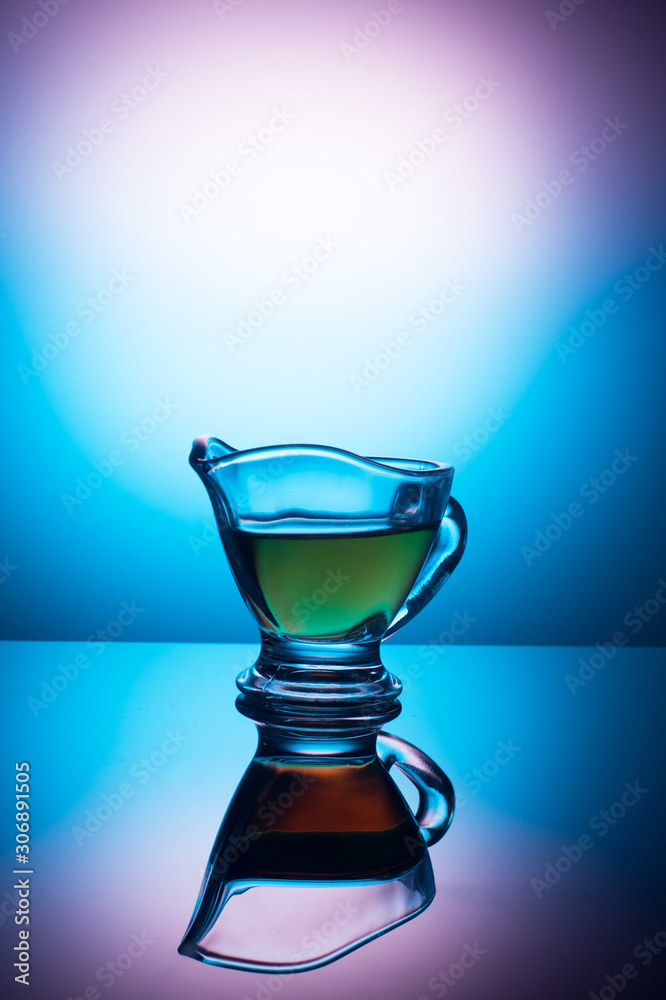 Two glass cups with a pattern, with fragrant tea on a colored background Two glass cups with a pattern, with fragrant tea on a colored background