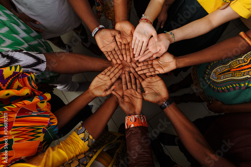 Palms up hands of happy group of multinational African, latin american and european people which stay together in circle