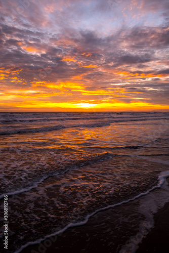 Reflection of vivid sunset sky over sea.Colorful sunrise with Clouds over ocean.Sky reflection on water.