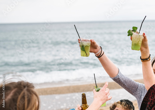 Group of friends during a party on the beach