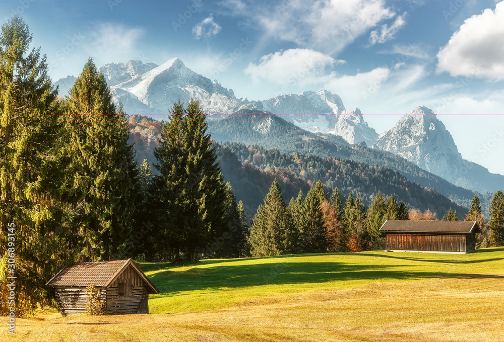 Scenic image of alpine valley in sunny day. Amazing summer Landscape with colorful Sky. Majestic Zugspitce mountain on the background. Wonderful natural Scenery. Bavarian Alps near Geroldsee lake