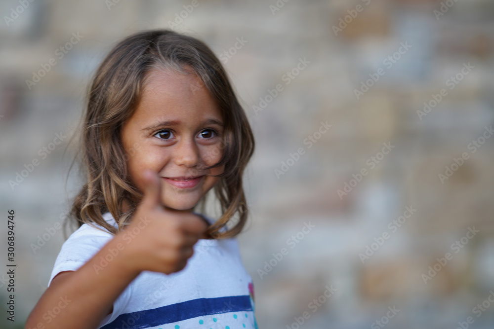 4 year old girl who smiles makes a sign of agreement 4 year old girl who smiles makes a sign of agreement