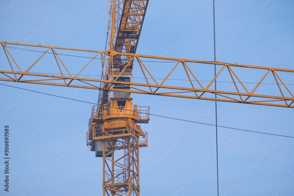 detail of building cranes with long arms at a construction site