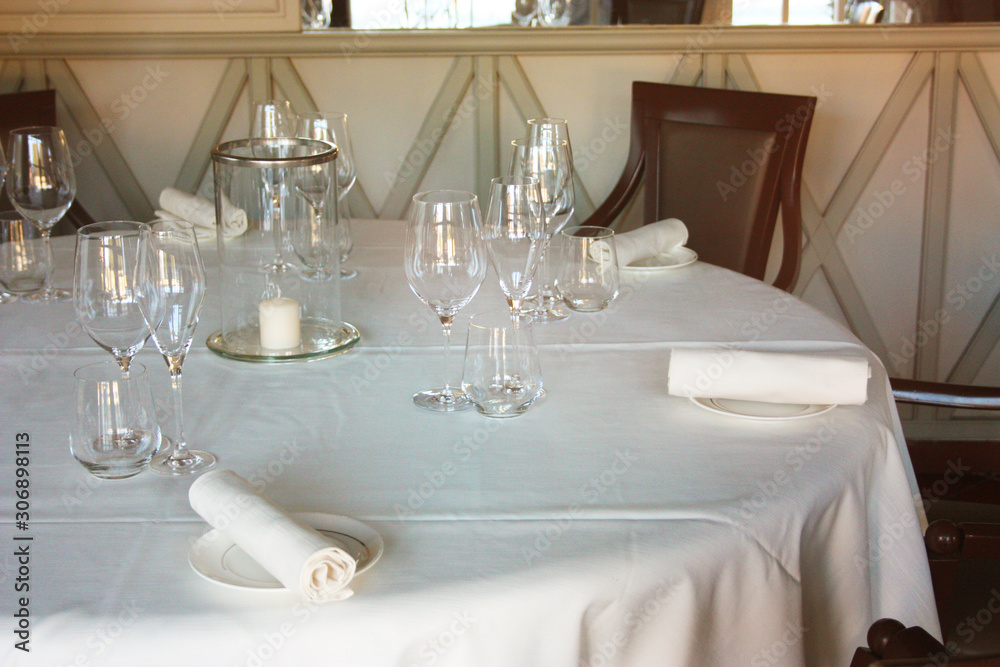 dining table set up and set up with a lot of elegance in the dining room of a restaurant or the dining room of a very rich house, in light white colors