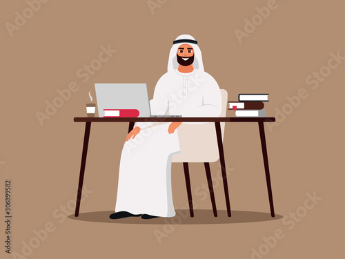 Young Arab man using laptop and sitting at the table. Happy Muslim employee wearing white clothes working at home or office. Color vector illustration in flat cartoon style.