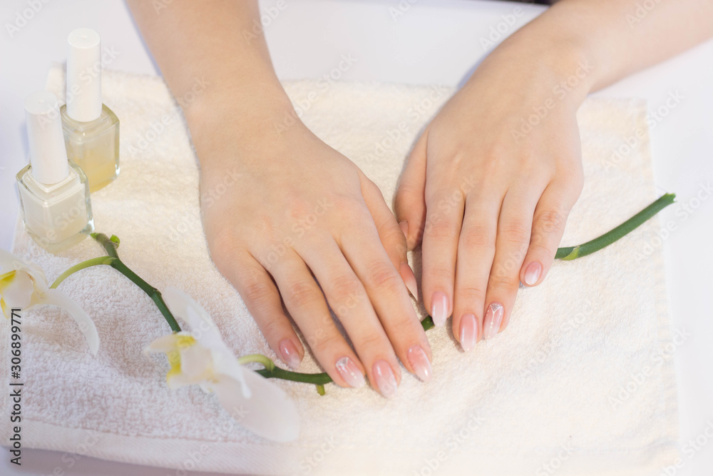Beautiful soft woman hands with light manicure hand care and spa relaxing  white orchid nail polish towel copy space Stock Photo | Adobe Stock