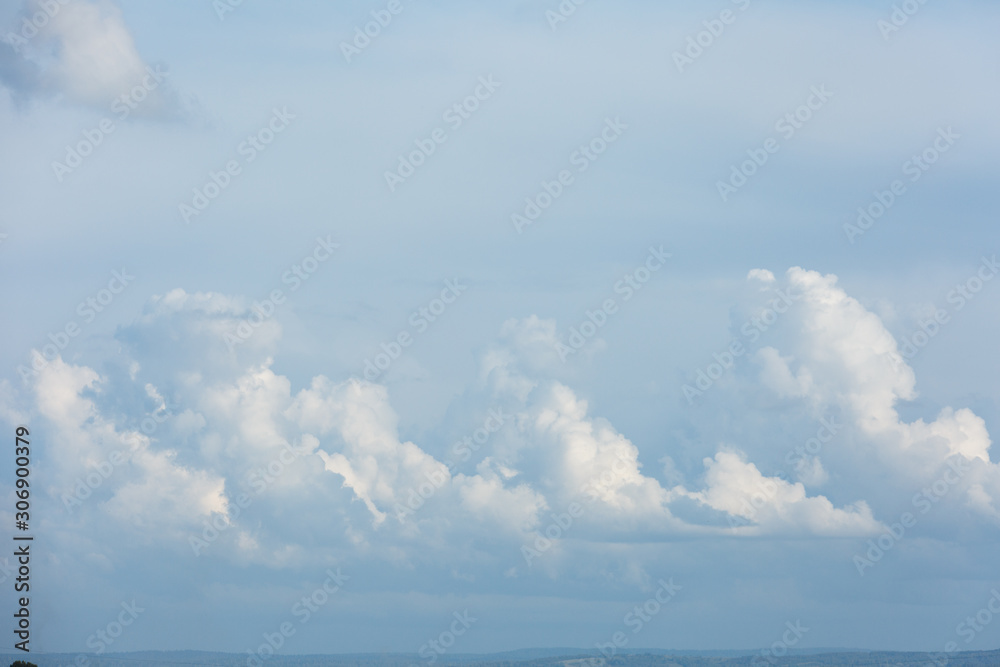 White and thick clouds in a blue sky. Cloudy sky.