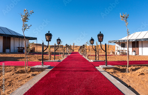 Obraz na płótnie Red Carpet Main path between the tents of luxury Golden Camp site in Sahara Desert Merzouga, Morocco on a sunny day w salonie