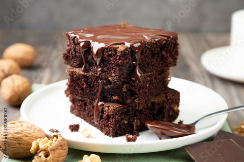 Delicious brownies with melted chocolate on a stack photo