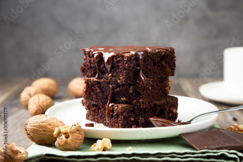 Chocolate brownies with walnuts and melted chocolate photo