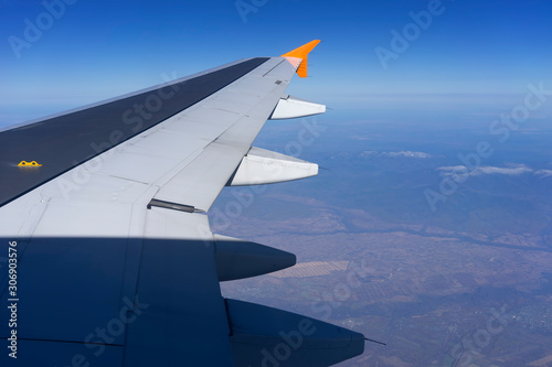 Aircraft wing on the background of the landscape.