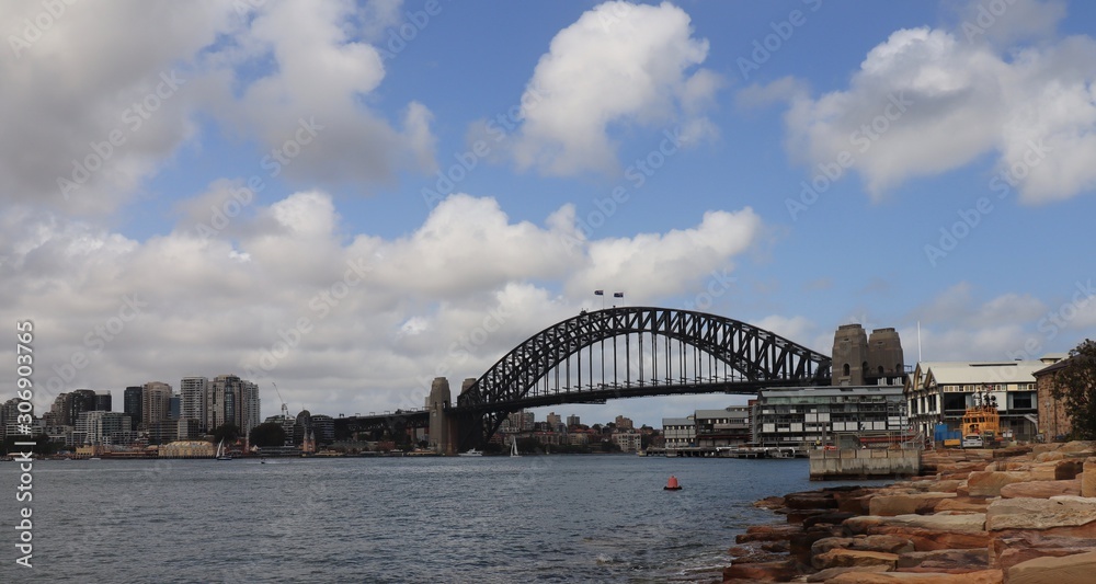 Naklejka premium Panorama Sydney Harbour bridge nsw australia Waves blue sky clouds 
