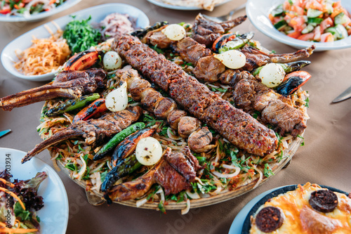 Fotografie Traditional Turkish Adana kebab or kebap meat food, appetizers, raki and salgam on table from top view in turkish restaurant