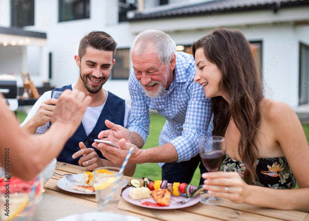 Portrait of people outdoors on family garden barbecue, taking selfie. Portrait of people outdoors on family garden barbecue, taking selfie.