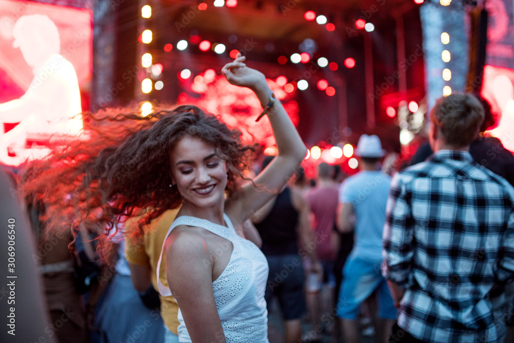 Beautiful young woman dancing at summer festival. Beautiful young woman dancing at summer festival.