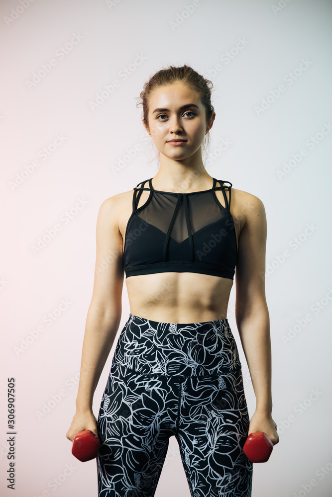 Young sports girls are engaged in fitness, lifestyle, sports and healthy eating, in the gym girls do exercises Young sports girls are engaged in fitness, lifestyle, sports and healthy eating, in the gym girls do exercises