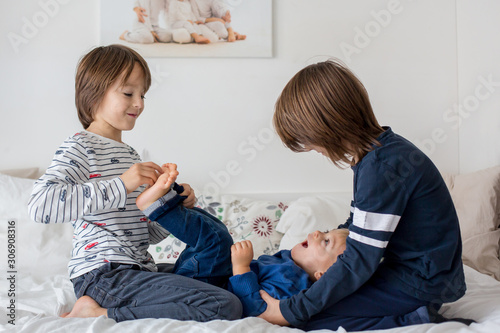 Brothers, playing at home, tickling feet laughing and smiling photo