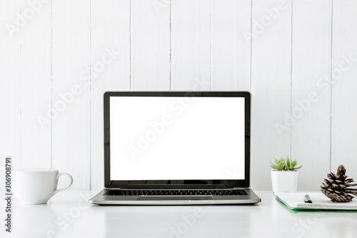 Digital technology Laptop muck up blank white screen and flower pot book on white table ,Home interior or office background