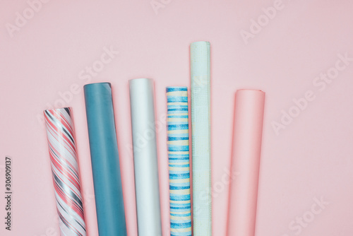 top view of wrapping paper rolls on pink
