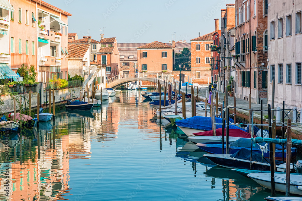 Houses and boats along a quiet canal in Giudecca, Venice, Italy