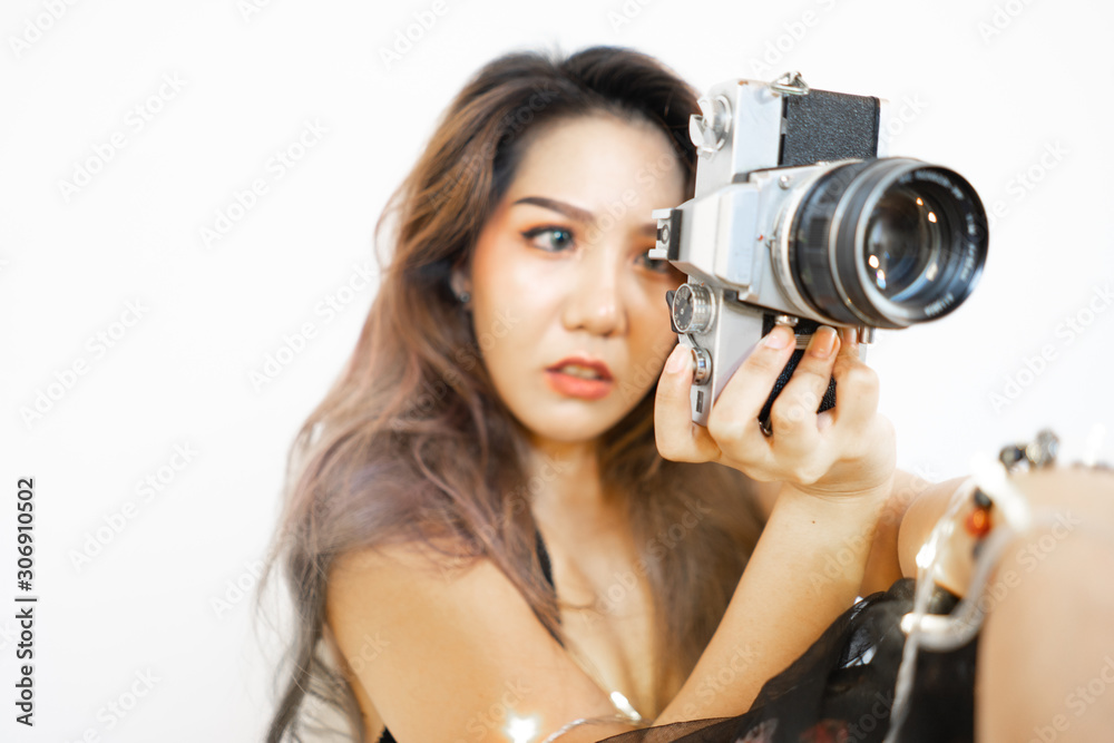 Young asian women photographer with camera on isolated background Young asian women photographer with camera on isolated background
