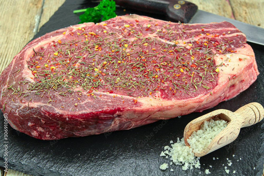 raw rib of beef on a wooden table