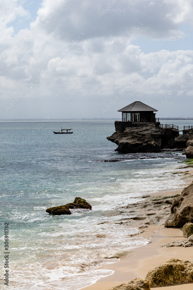beautiful coastal scenery with a wooden hut perched out at sea