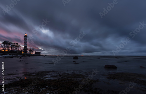 Stormy sunset on the Gulf of Finland at Shepelevsky lighthouse. Leningrad region. Russia