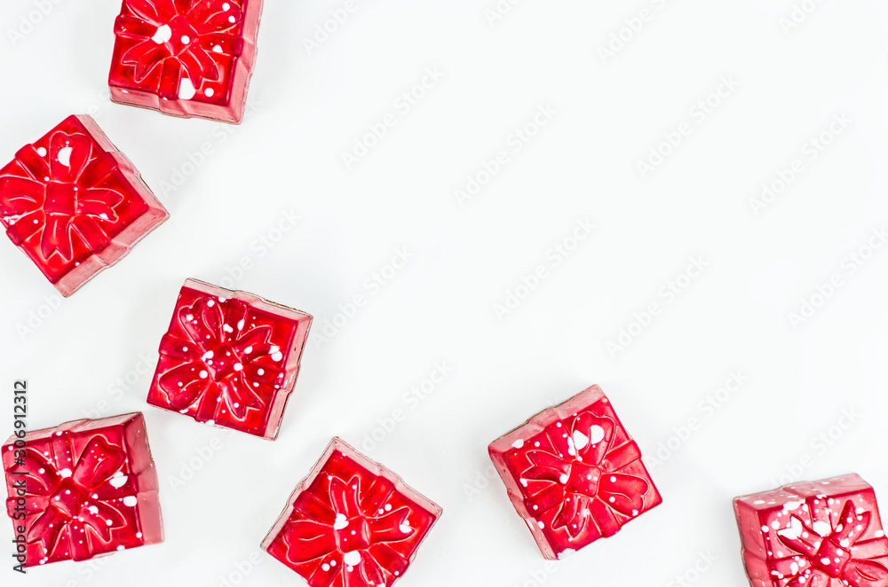 Fototapeta premium Christmas. New Year's Eve. Background. red candy in the form of gifts on a white background