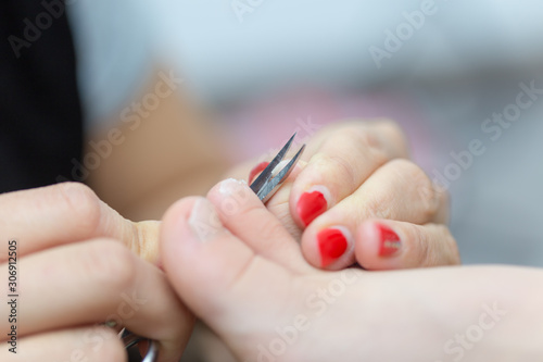 mom cuts baby s nails with protective scissors