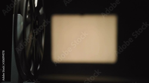Video of film projector filming on black background