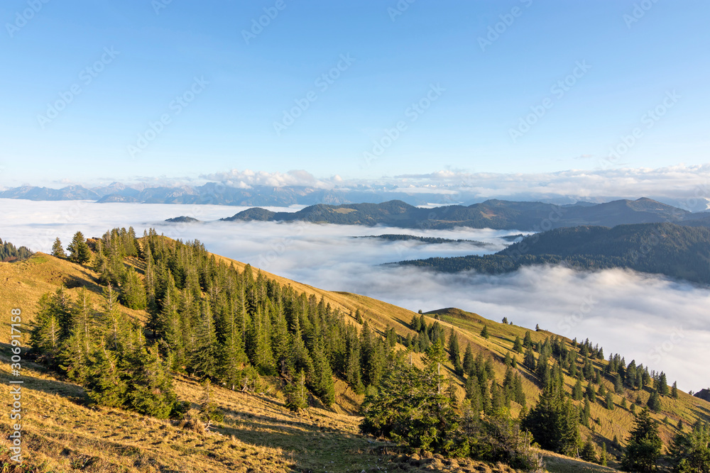 Hills and mountains sticking out of a cloud layer at sunset. Allgau Alps, Bavaria, Germany.