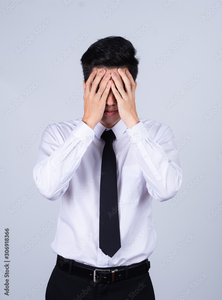 Portrait handsome young asian .businessman wearing a white shirt excitement or celebrating his victory sign isolated on grey background in studio. Asian man people. business success concept. Portrait handsome young asian .businessman wearing a white shirt excitement or celebrating his victory sign isolated on grey background in studio. Asian man people. business success concept.
