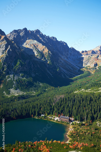 The beautiful autumn Poprad lake surrounded by high peaks of Tatra mountains in Slovakia - Portrait oriented landscape