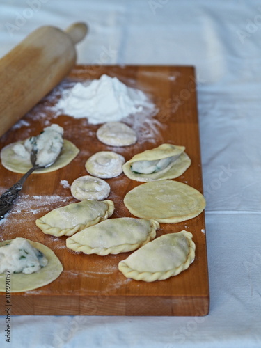 dumplings on a cutting board on a rustic table
