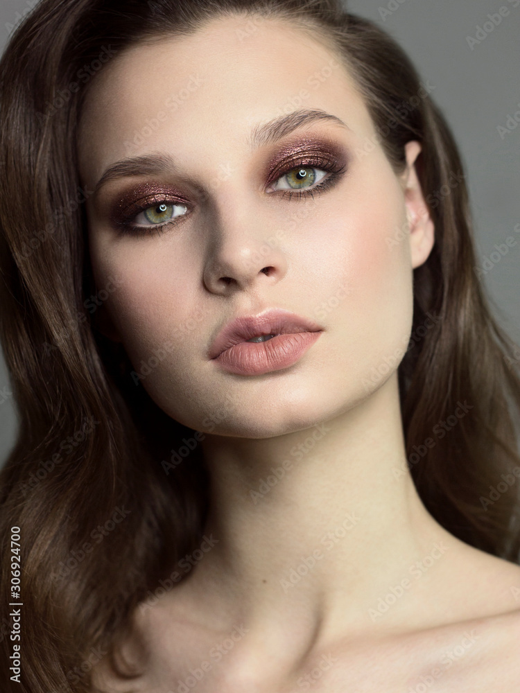 Close-up portrait of beautiful woman's purity face with dark green smoky-eyes make-up, pale full lips. Sexy model with clean shiny skin, purity complexion Close-up portrait of beautiful woman's purity face with dark green smoky-eyes make-up, pale full lips. Sexy model with clean shiny skin, purity complexion