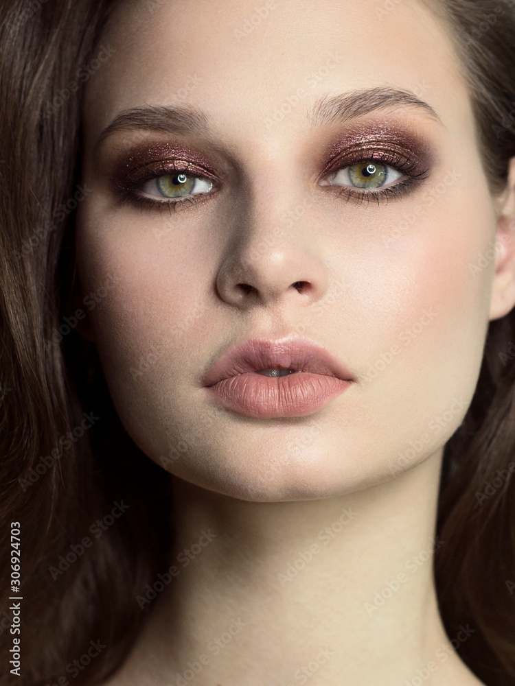 Beautiful brunet model woman face with green eyes and perfect make-up. Portrait of beauty young brunet girl with natural lips and smoky eyes, thick eyesbrow . Female face with clear skin close-up. Beautiful brunet model woman face with green eyes and perfect make-up. Portrait of beauty young brunet girl with natural lips and smoky eyes, thick eyesbrow . Female face with clear skin close-up.