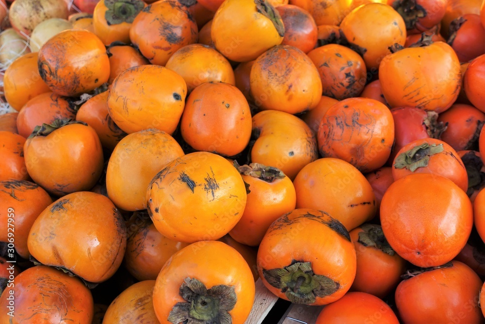  closeup of persimmons on display at the market