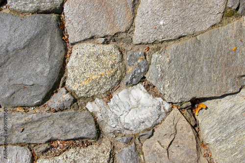 Closeup of an old pavement cobbled with natural rocks photo