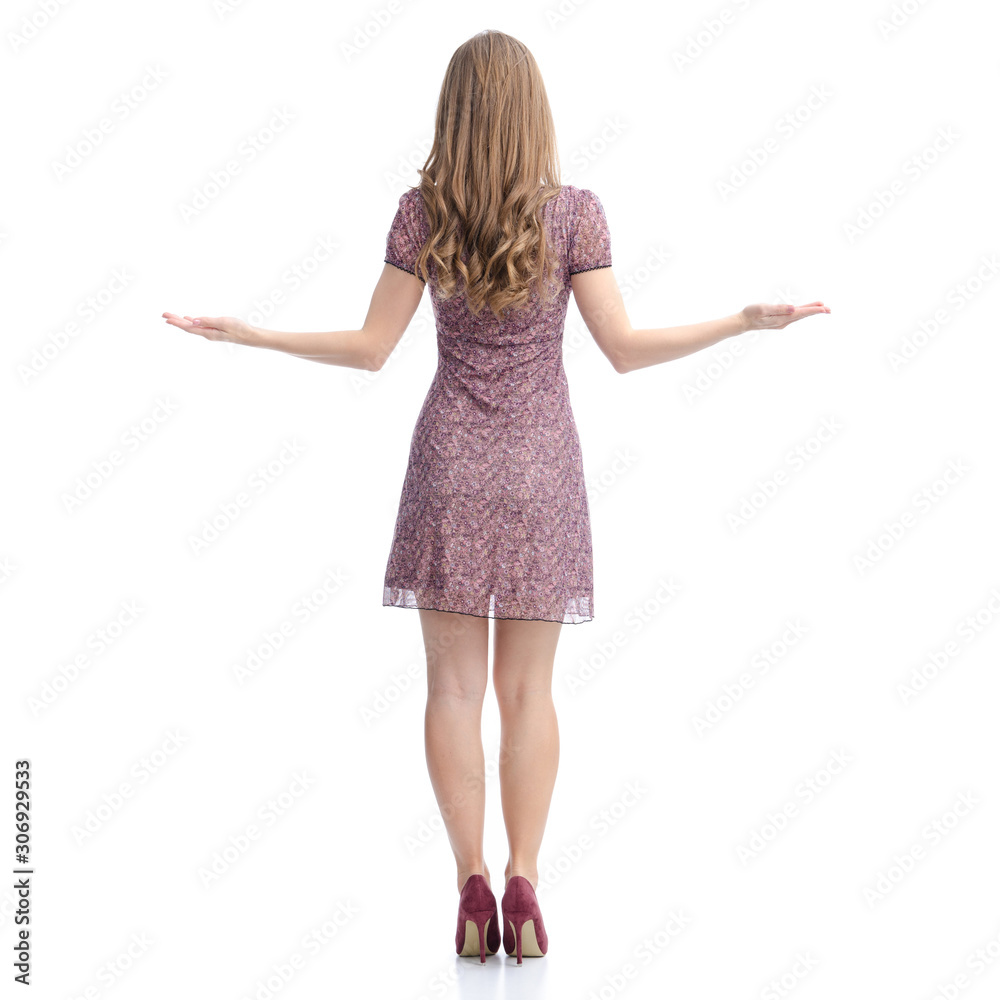 Woman in dress and high heels standing pointing showing equilibrium balance on white background isolation, back view Woman in dress and high heels standing pointing showing equilibrium balance on white background isolation, back view