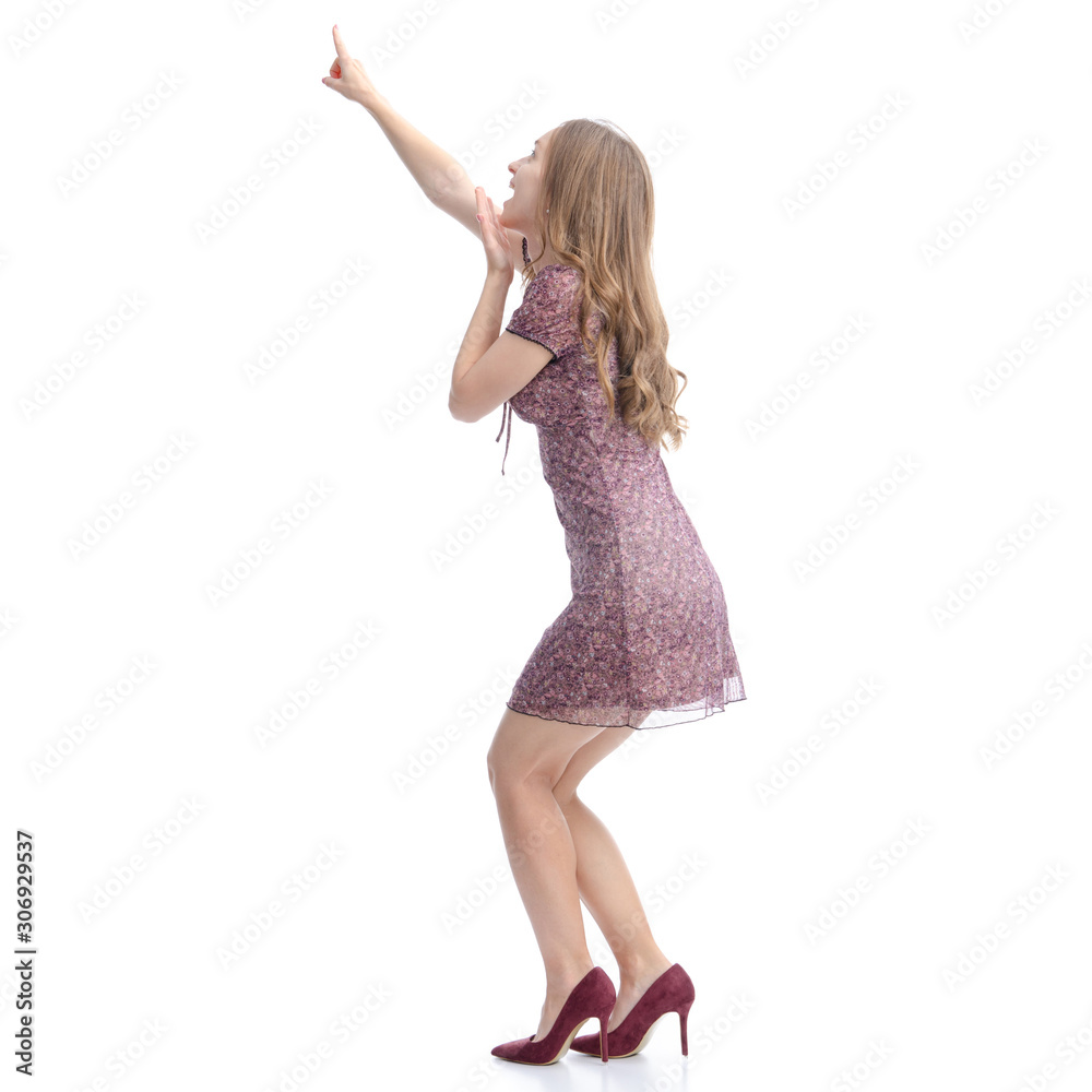 Woman in dress and high heels standing pointing showing on white background isolation, back view Woman in dress and high heels standing pointing showing on white background isolation, back view