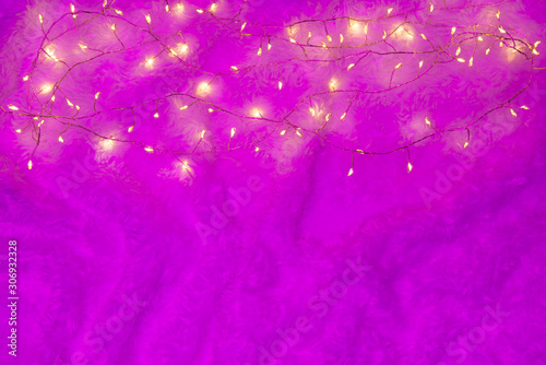 Christmas lights over a bright violet fluffy background