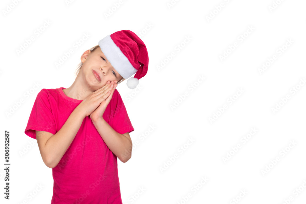 Child girl in santa hat smile and pink t-shirt
