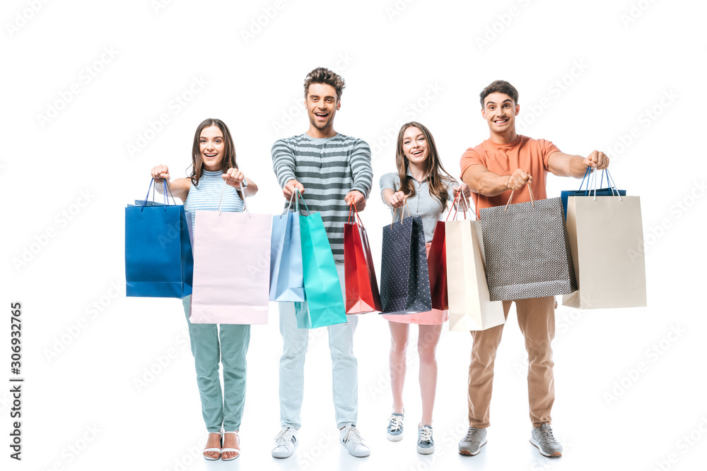 excited friends holding shopping bags together, isolated on white excited friends holding shopping bags together, isolated on white