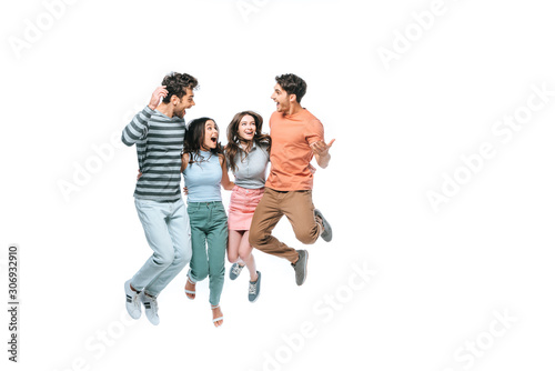 excited friends jumping and celebrating triumph, isolated on white
