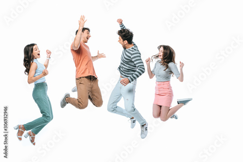 excited friends jumping together, isolated on white