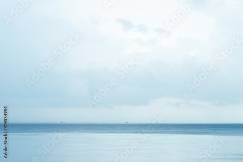 Soft blue abstract sky over the beach, some cloud flowing, color gradient in layer