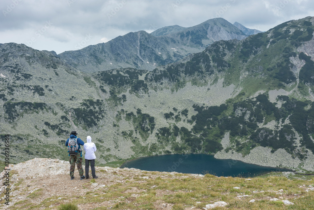 Hikers enjoying the beautiful nature on cloudy weather. National park Pirin. Selective focus. Healthy lifestyle concept, be active, adventure.