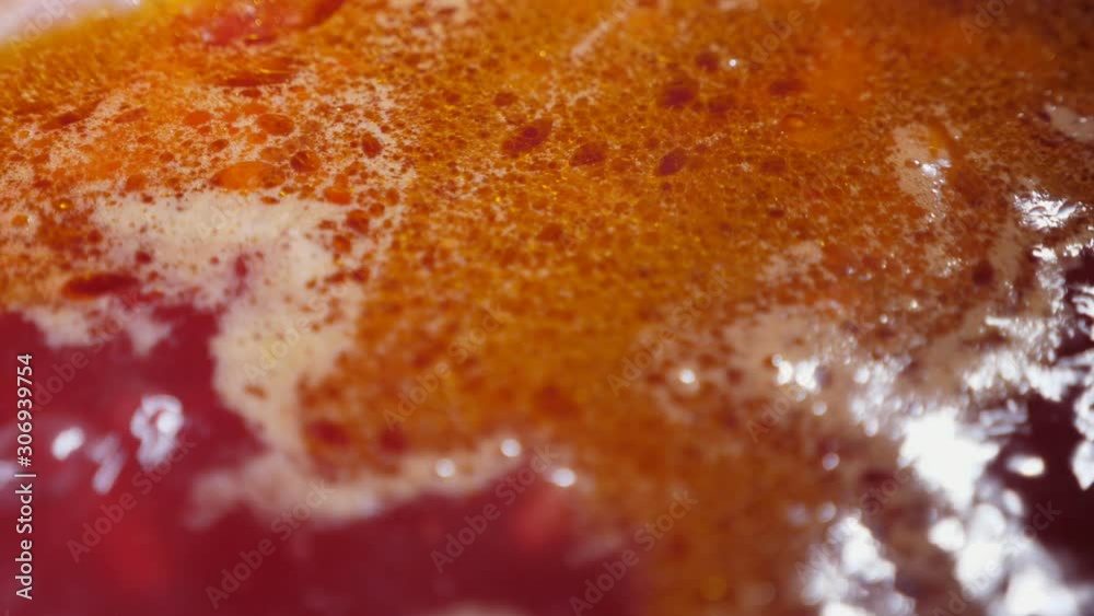 Tasty red Ukrainian borscht is boiling in a large metallic stewpot in a kitchen Tasty red Ukrainian borscht is boiling in a large metallic stewpot in a kitchen