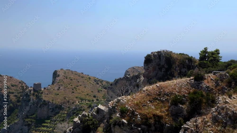 Locked Off View Off Rocky Outcrop On Amalfi Coast With Sea And Blue Sky In The Background Locked Off View Off Rocky Outcrop On Amalfi Coast With Sea And Blue Sky In The Background